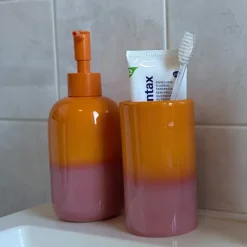 Xenos Tandenborstelbekers|Badkamer Accessoires-Tandenborstel beker duo - oranje/roze - ø6.5x11.5 cm